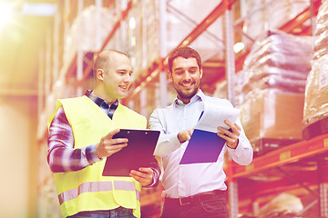 Image showing worker and businessmen with clipboard at warehouse