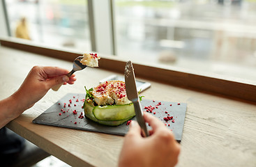 Image showing woman eating goat cheese salad at restaurant