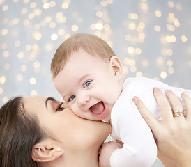 Image showing happy mother kissing adorable baby