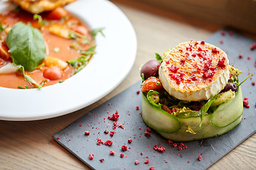 Image showing goat cheese salad and gazpacho soup at restaurant