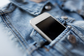 Image showing smartphone in pocket of denim jacket or waistcoat