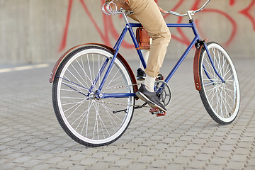 Image showing close up of hipster man riding fixed gear bike