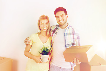 Image showing smiling couple with big boxes moving to new home