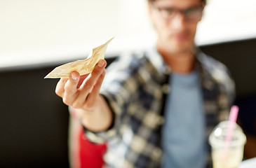 Image showing happy man with cash money paying at cafe