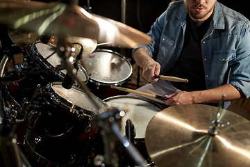 Image showing male musician playing drums and cymbals at concert