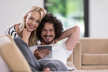 Image showing couple relaxing at  home with tablet computers