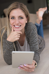 Image showing young women used tablet computer on the floor