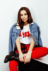 Image showing young pretty teenage hipster girl posing emotional happy smiling on white background, lifestyle people concept 