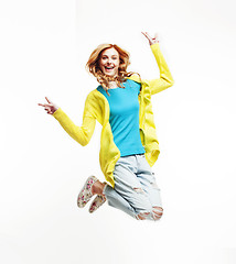 Image showing young pretty teenage girl jumping cheerful isolated on white background, lifestyle people concept