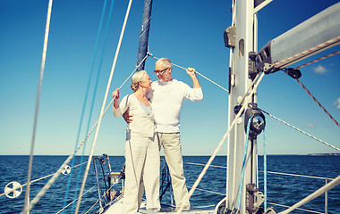 Image showing senior couple hugging on sail boat or yacht in sea