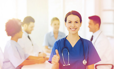 Image showing happy doctor over group of medics at hospital