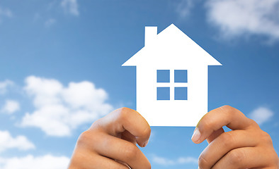 Image showing close up of hands holding paper house