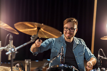 Image showing male musician playing drums and cymbals at concert