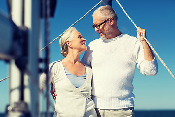 Image showing senior couple hugging on sail boat or yacht in sea