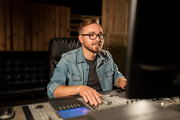 Image showing man at mixing console in music recording studio