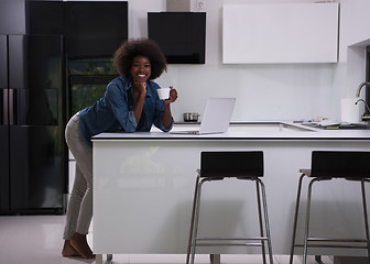 Image showing smiling black woman in modern kitchen