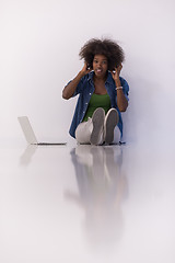 Image showing african american woman sitting on floor with laptop