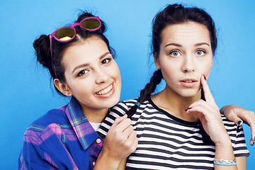 Image showing best friends teenage girls together having fun, posing emotional on blue background, besties happy smiling, lifestyle people concept 