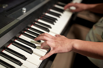 Image showing close up of hands playing piano