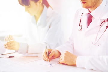 Image showing doctor and nurse writing prescription paper