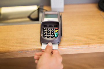 Image showing close up of hand inserting bank card to terminal