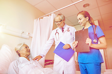 Image showing doctor and nurse visiting senior woman at hospital