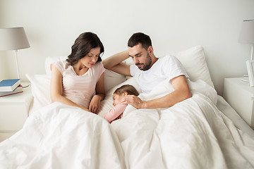 Image showing happy family sleeping in bed at home