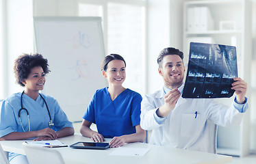 Image showing group of happy doctors discussing x-ray image