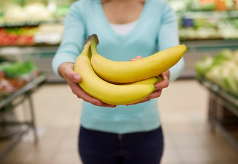 Image showing woman with bananas at grocery store