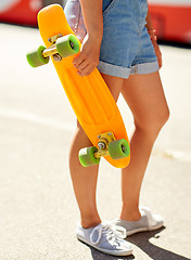 Image showing teenage girl with skateboard on city street