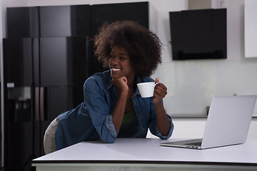 Image showing smiling black woman in modern kitchen