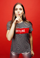 Image showing young pretty emitonal posing teenage girl on bright red background, happy smiling lifestyle people concept