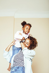 Image showing adorable sweet young afro-american mother with cute little daughter, hanging at home, having fun playing smiling, lifestyle people concept, happy smiling modern family