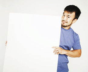 Image showing pretty cool asian man holding empty white plate smiling