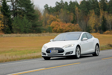 Image showing White Tesla Electric Car at Speed in Autumn