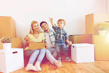 Image showing happy family with boxes moving to new home