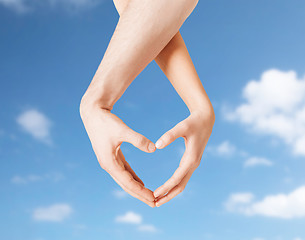 Image showing woman and man hands making heart symbol