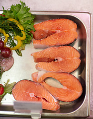 Image showing salmon fish fillet in metal tray on ice at grocery