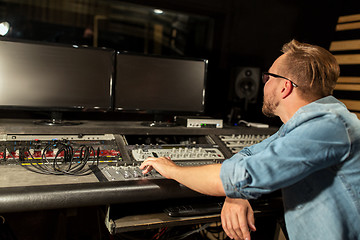 Image showing man at mixing console in music recording studio