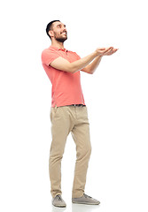 Image showing happy man holding something imaginary on hands