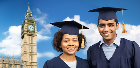 Image showing happy students or bachelors in mortar boards