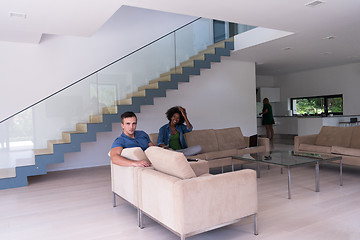 Image showing young multiethnic couple relaxes in the living room