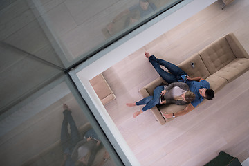 Image showing youg couple in living room with tablet top view