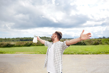 Image showing man or farmer with jug of milk at countryside