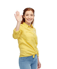 Image showing happy smiling woman waving hand over white