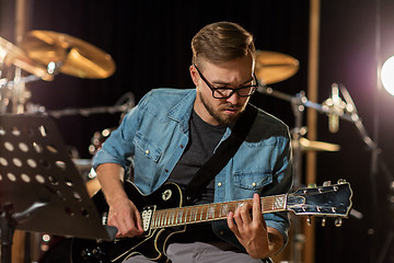 Image showing man playing guitar at studio rehearsal