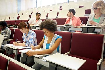 Image showing group of students with notebooks at lecture hall