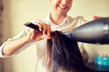 Image showing  close up of stylist making hairdo at salon