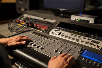 Image showing man using mixing console in music recording studio