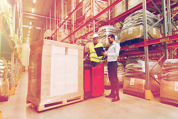 Image showing worker on forklift and businessman at warehouse